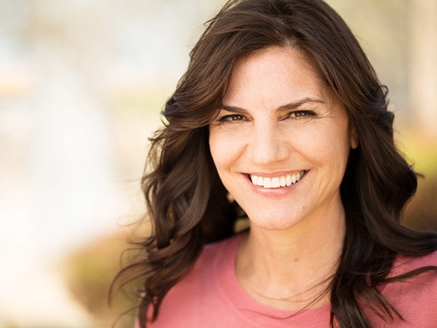 Woman with dentures in Cherry Hill smiling outside