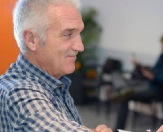 Dentist and dentistry patient discussing the cost of dental implants