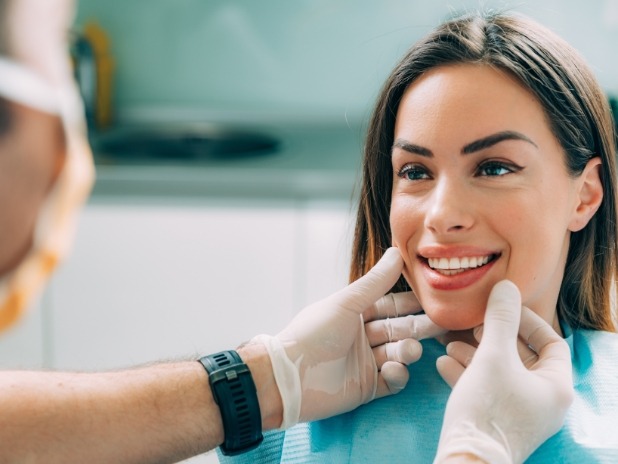 Dentist looking at woman's smile during dental appointment