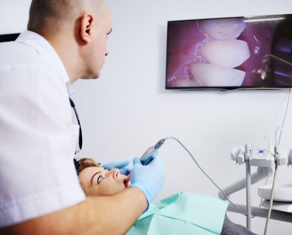 Dentist using intraoral camera to capture smile images